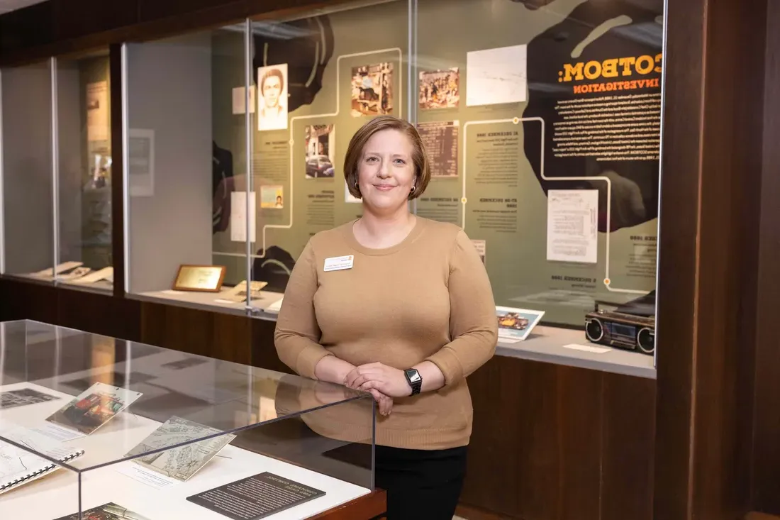 Researcher standing next to exhibit.